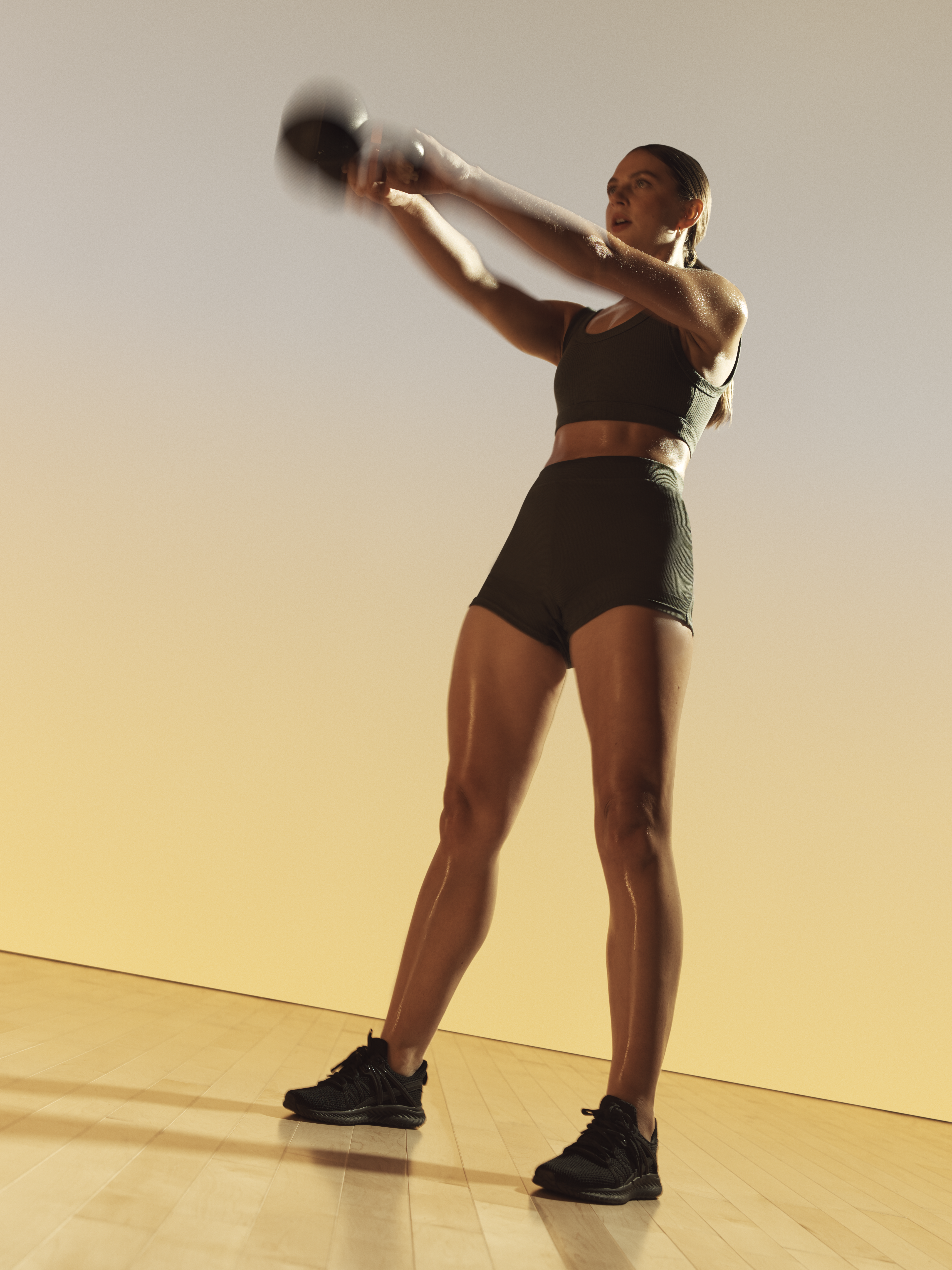 Xtreme cardio class member swinging a kettlebell at Life Time