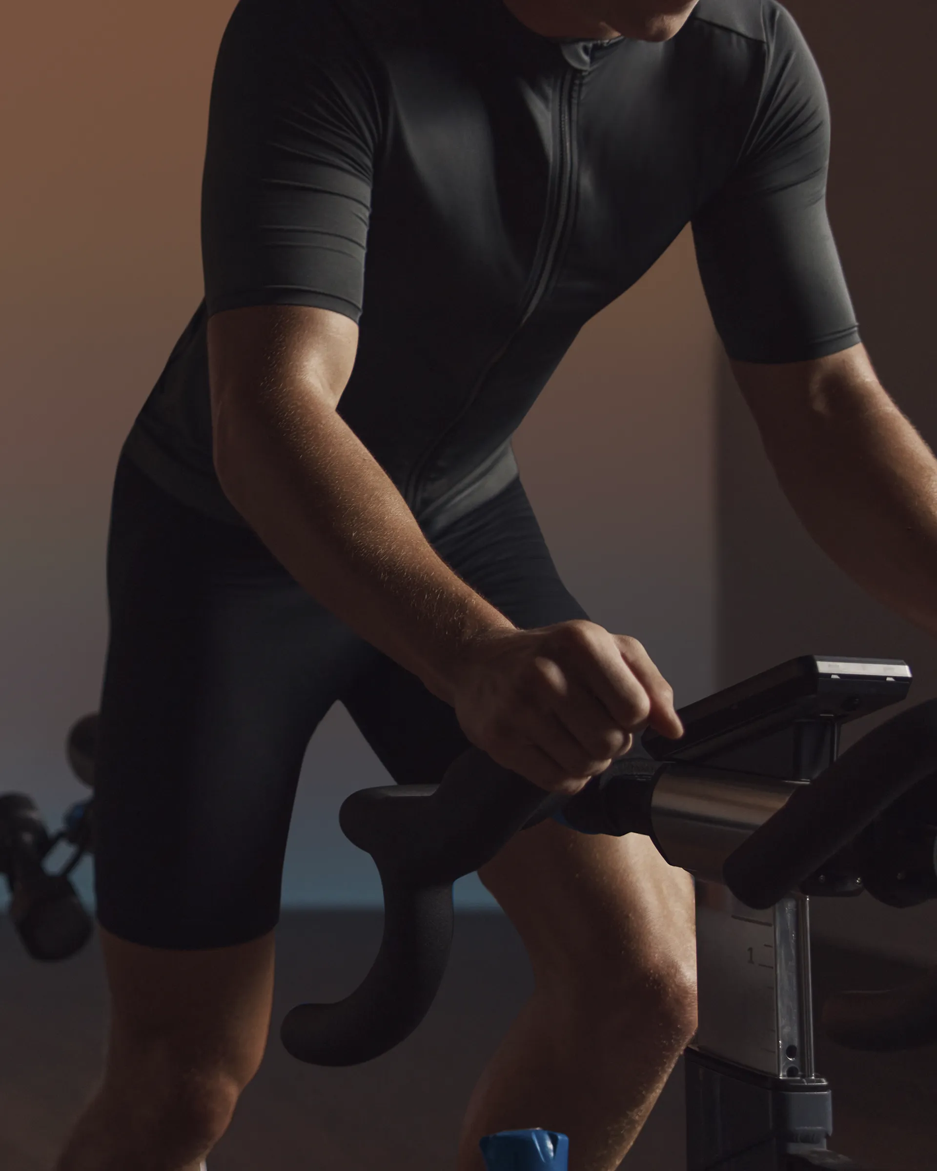 A cyclist seated on the bike riding in an EDG spin class