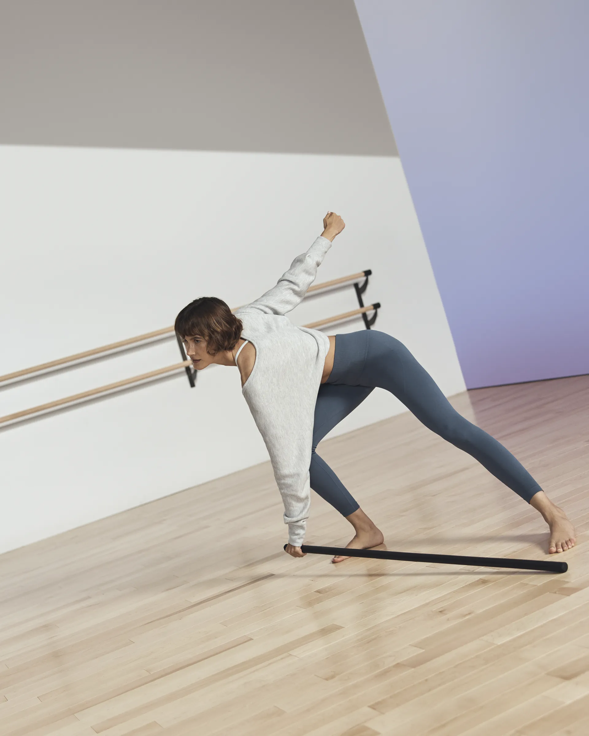 Life barre participant in forward bend position with body bar