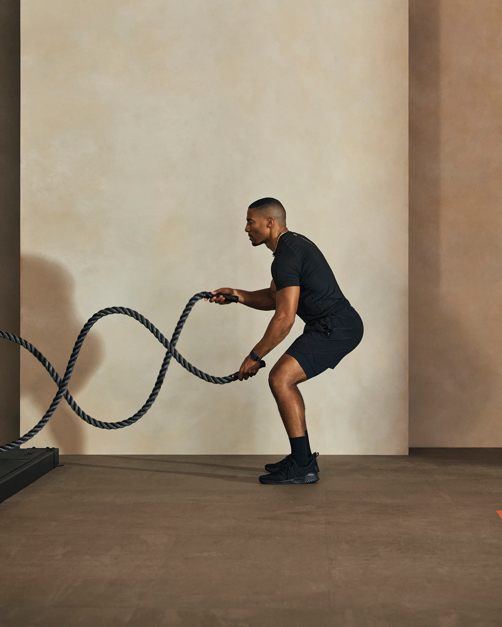 A Life Time member holding battle ropes for an Alpha class.