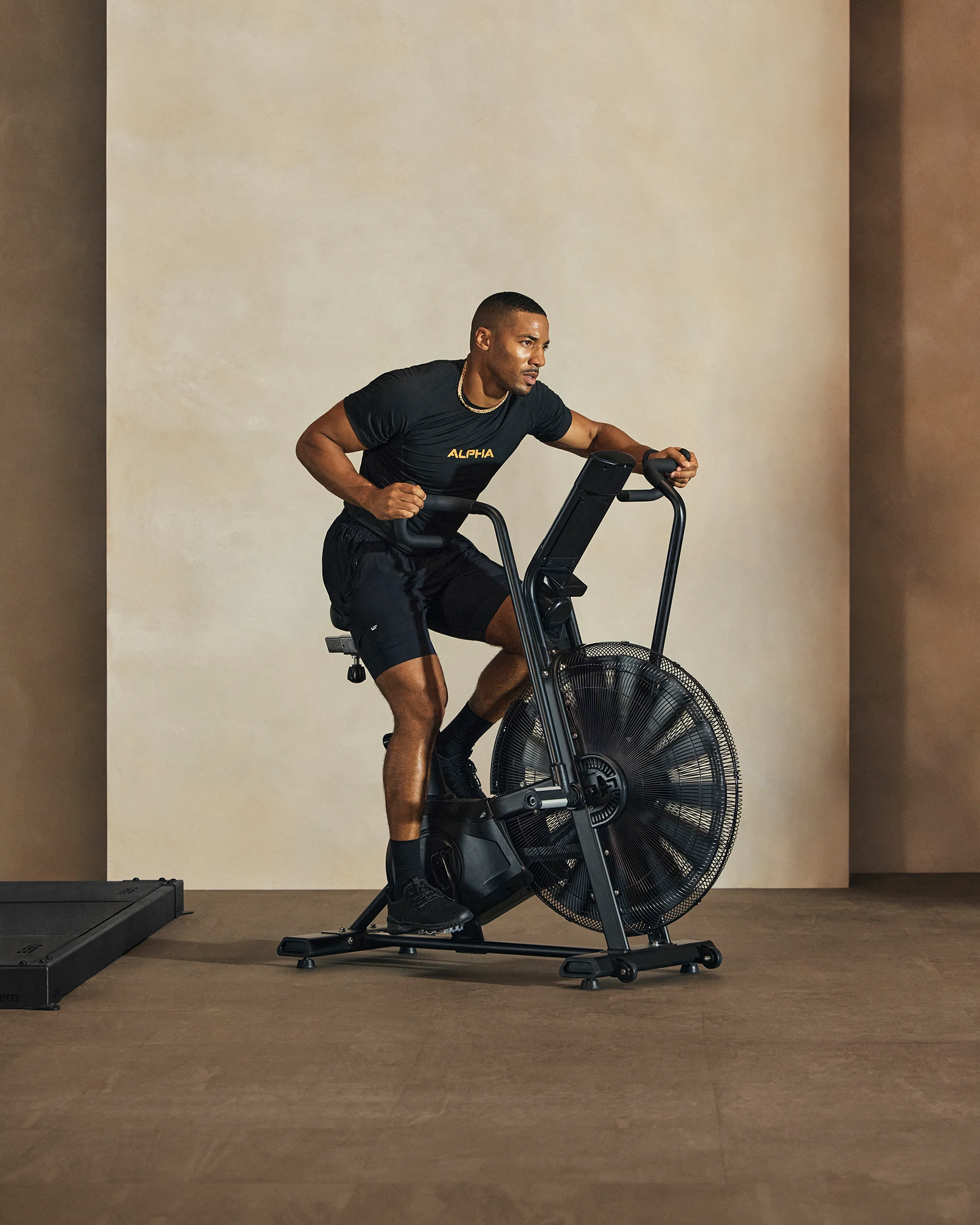 A Life Time member riding an assault stationary bike.