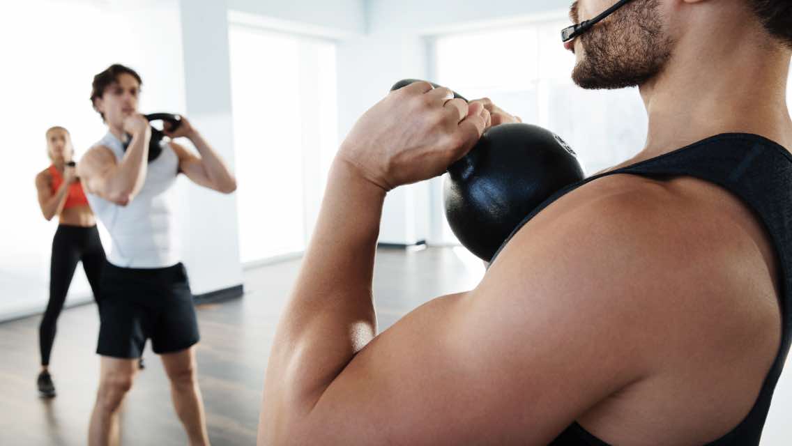 Male teaching a group fitness class at an EMPOWER event.