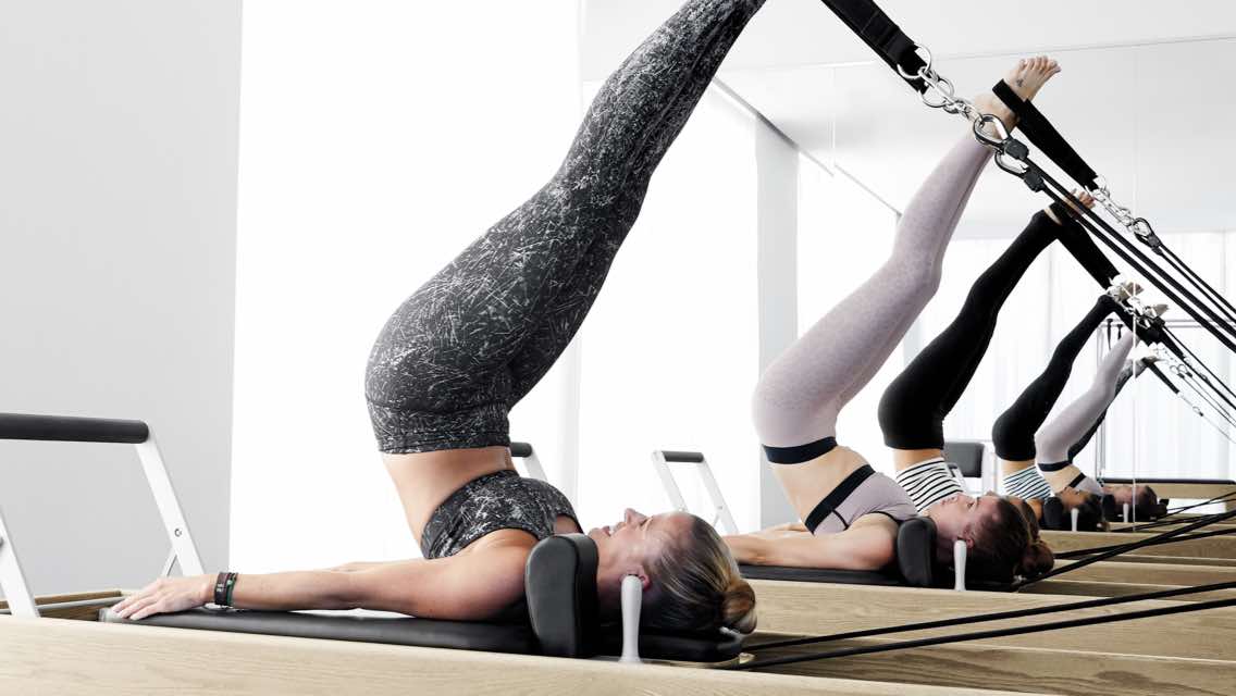 Smiling woman working out in an indoor water aerobics class at Life Time