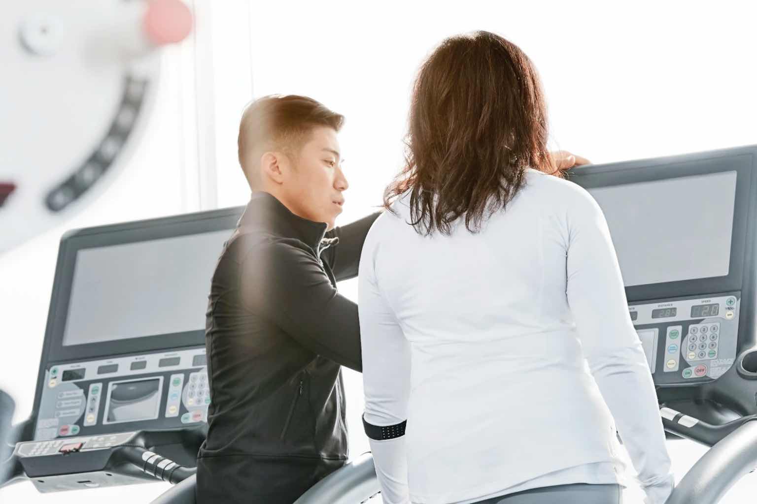 a woman with a personal trainer