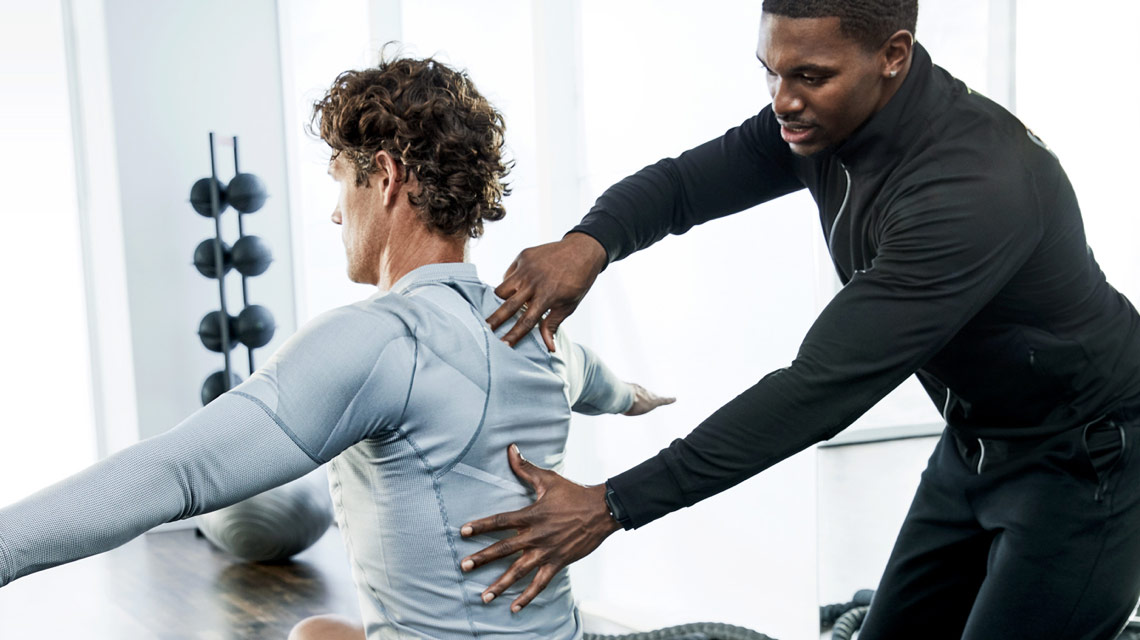 A man working with his personal trainer at Life Time