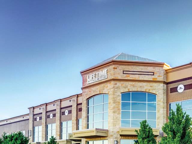 A view of a Life Time building in the day time