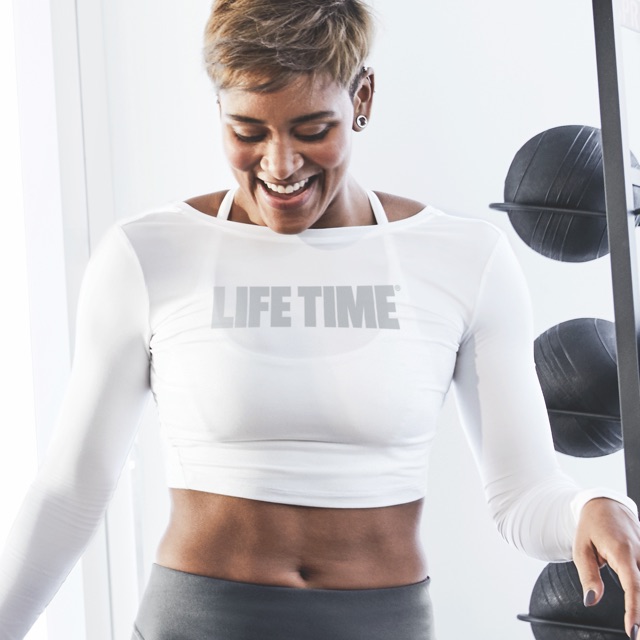 Woman working out with a personal trainer at Life Time