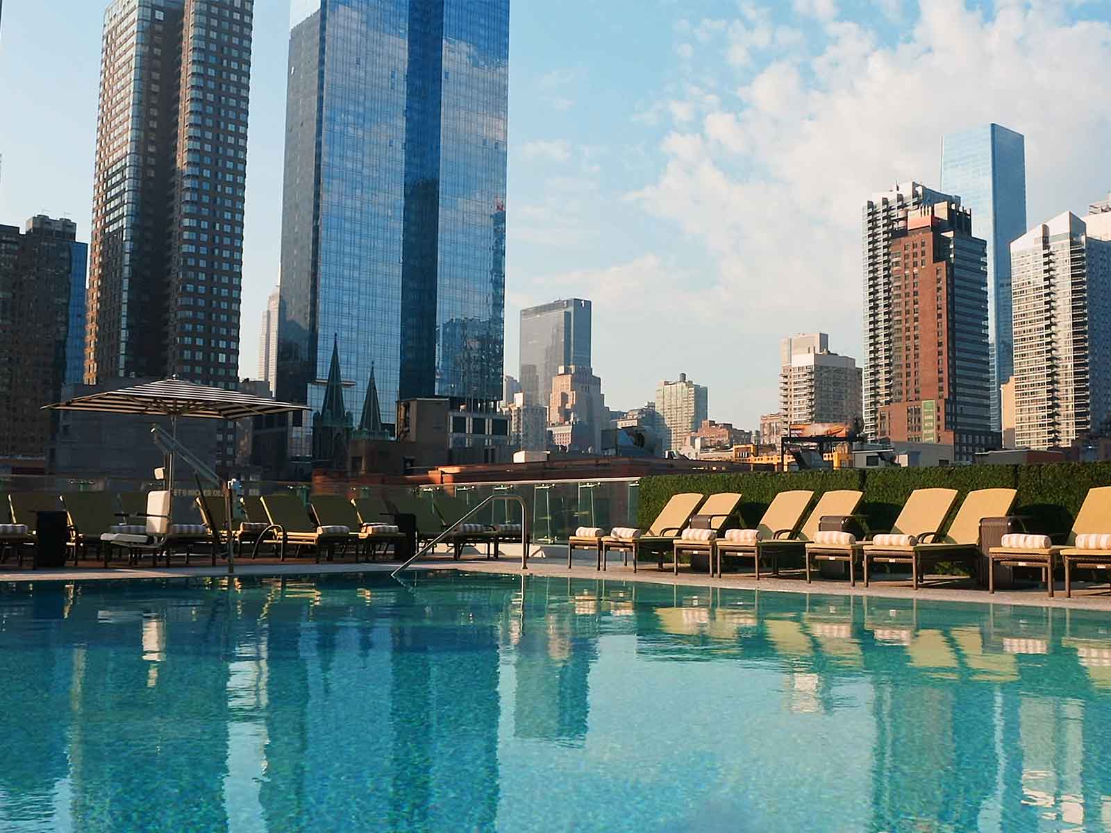 rooftop poolside with a view of a city skyline