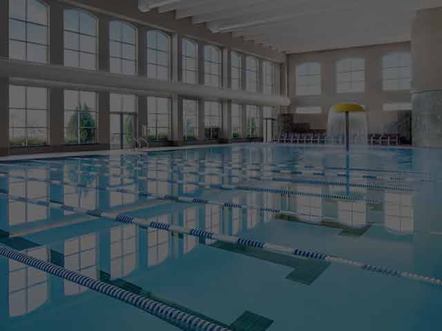 An image of an indoor pool at a Life Time facility