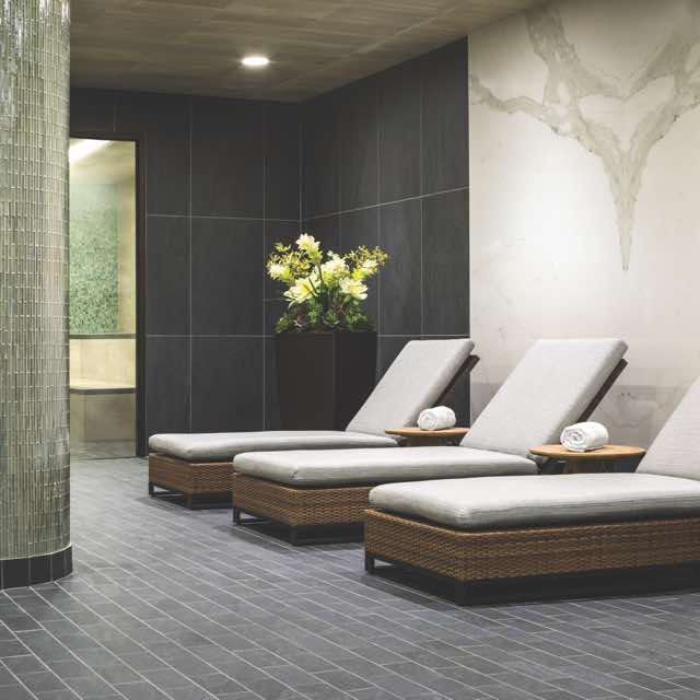 3 lounge chairs in a tiled room