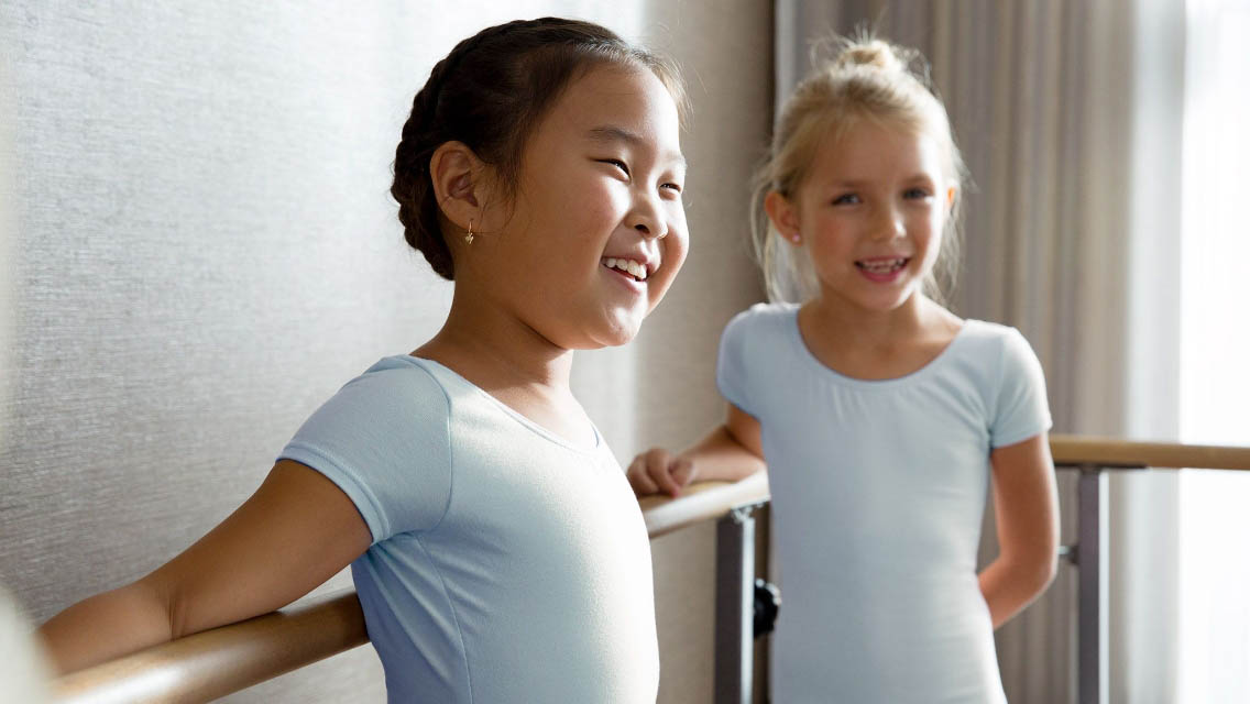 Two young girls in a dance class together