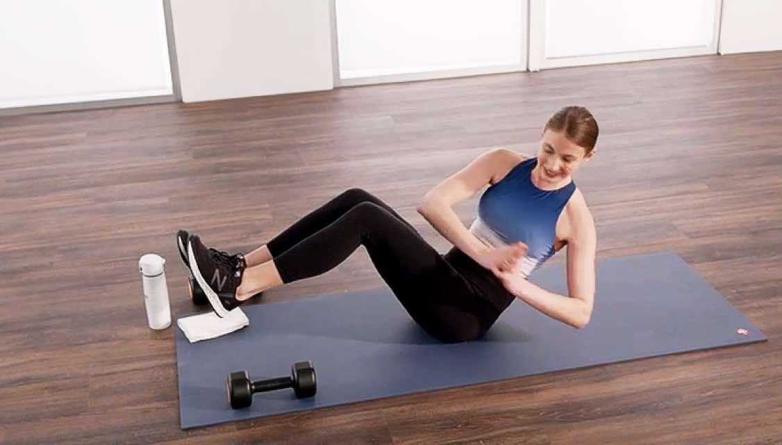 a woman preforms a twist ab crunch