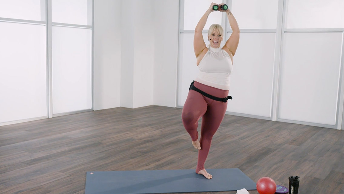 Woman taking a Life bar class at home with Life Time Classes On Demand