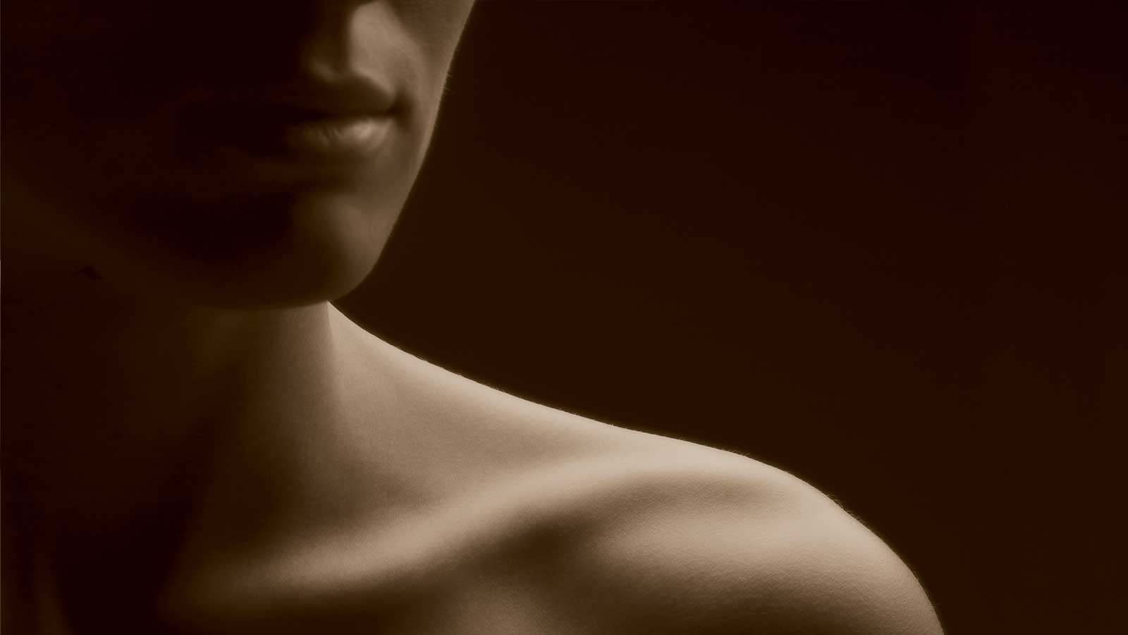 A woman's chin and shoulder