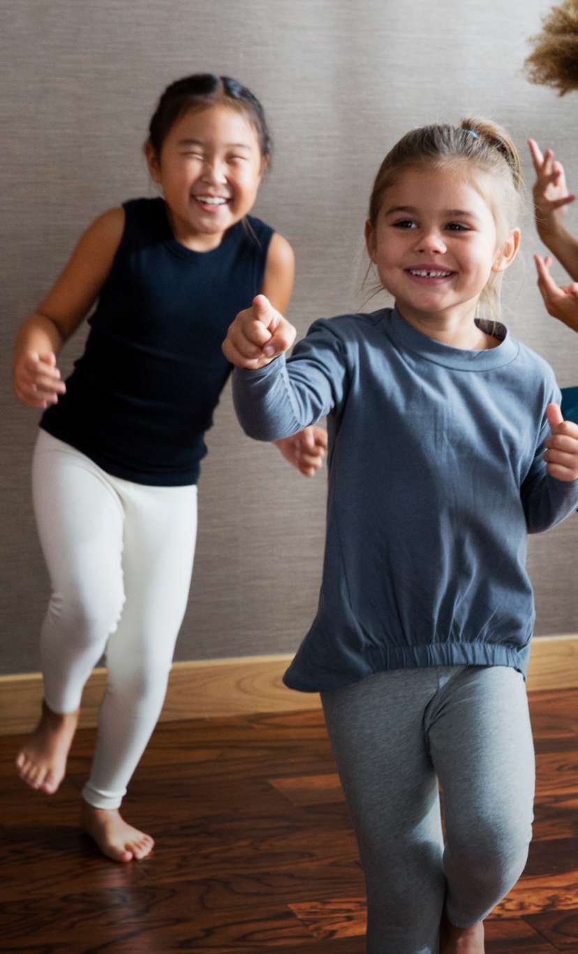 four children dance and play in a studio space