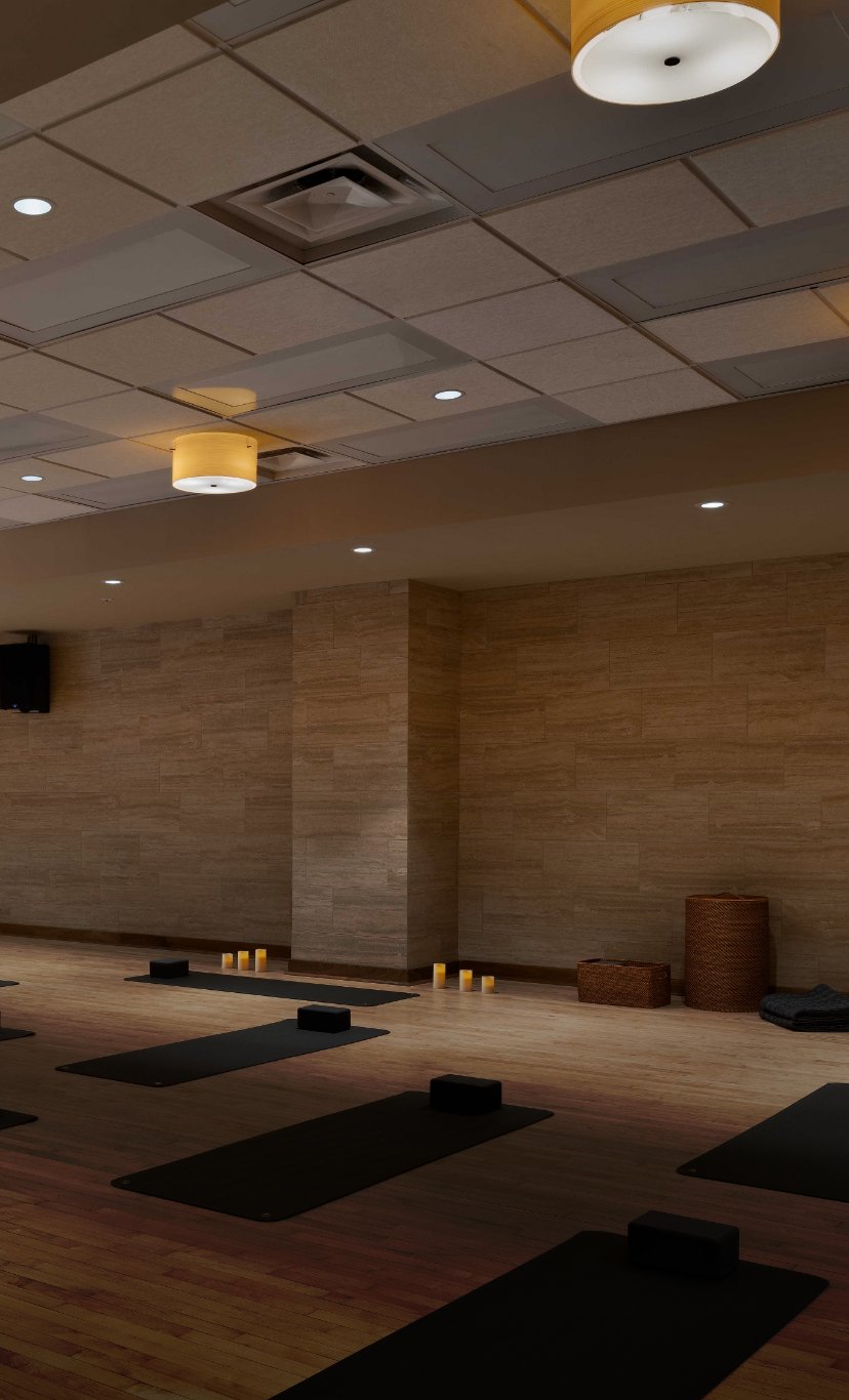 A dimly lit fitness studio with candles