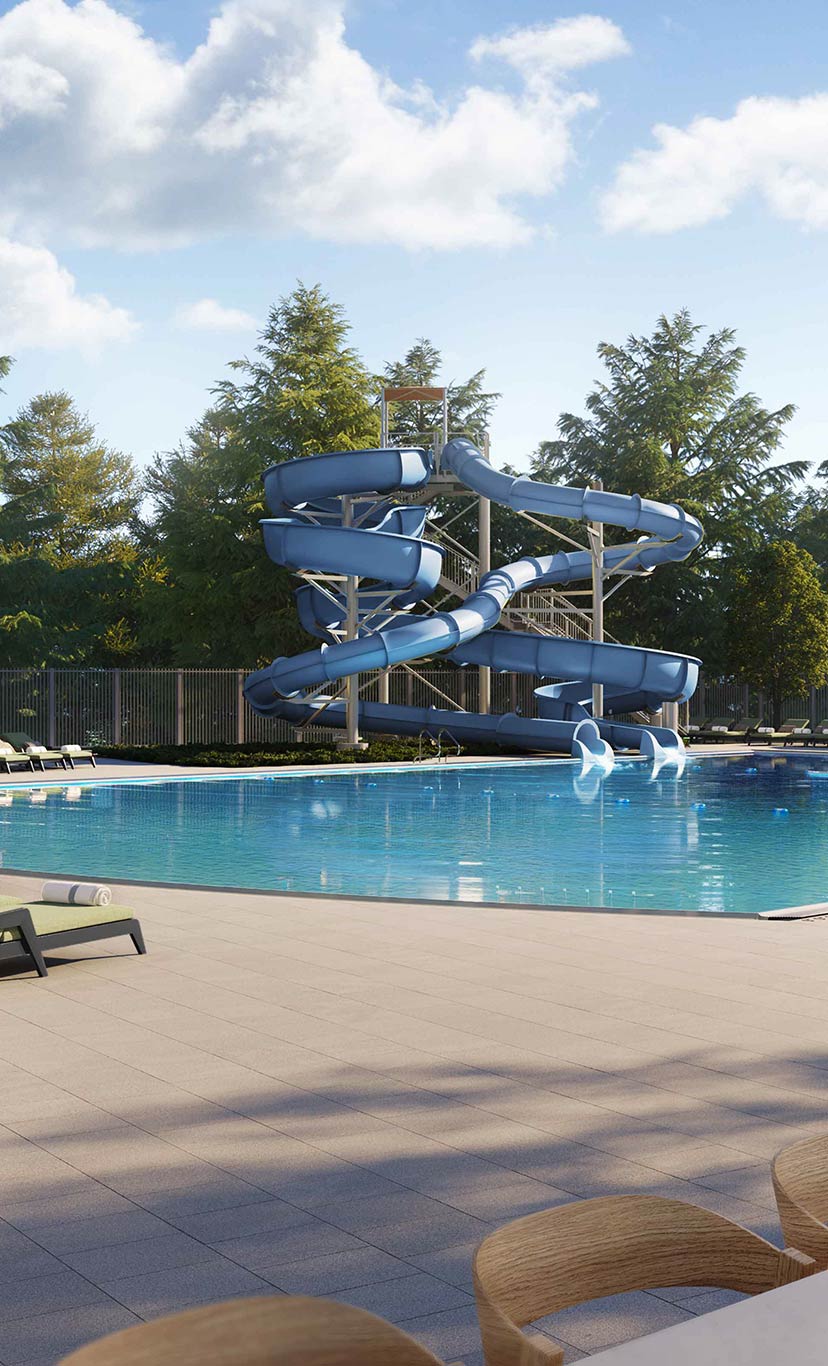 A large outdoor leisure pool and deck with lounge chairs and umbrellas