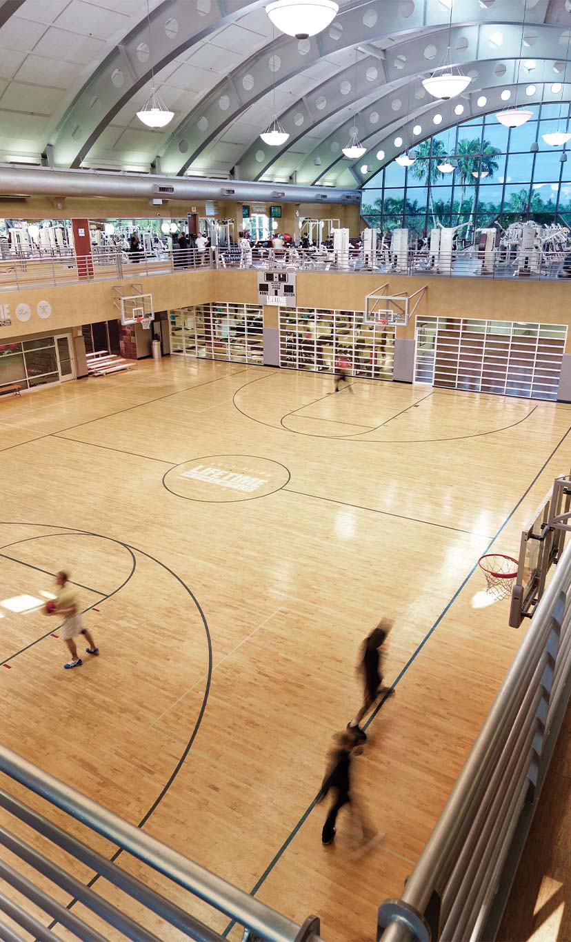 people playing basketball in an open topped basketball gymnasium