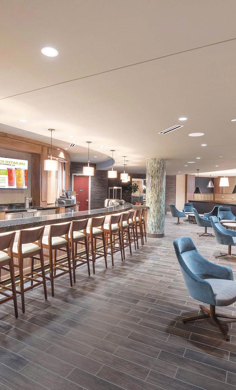 the bar and lounge area with many seating options