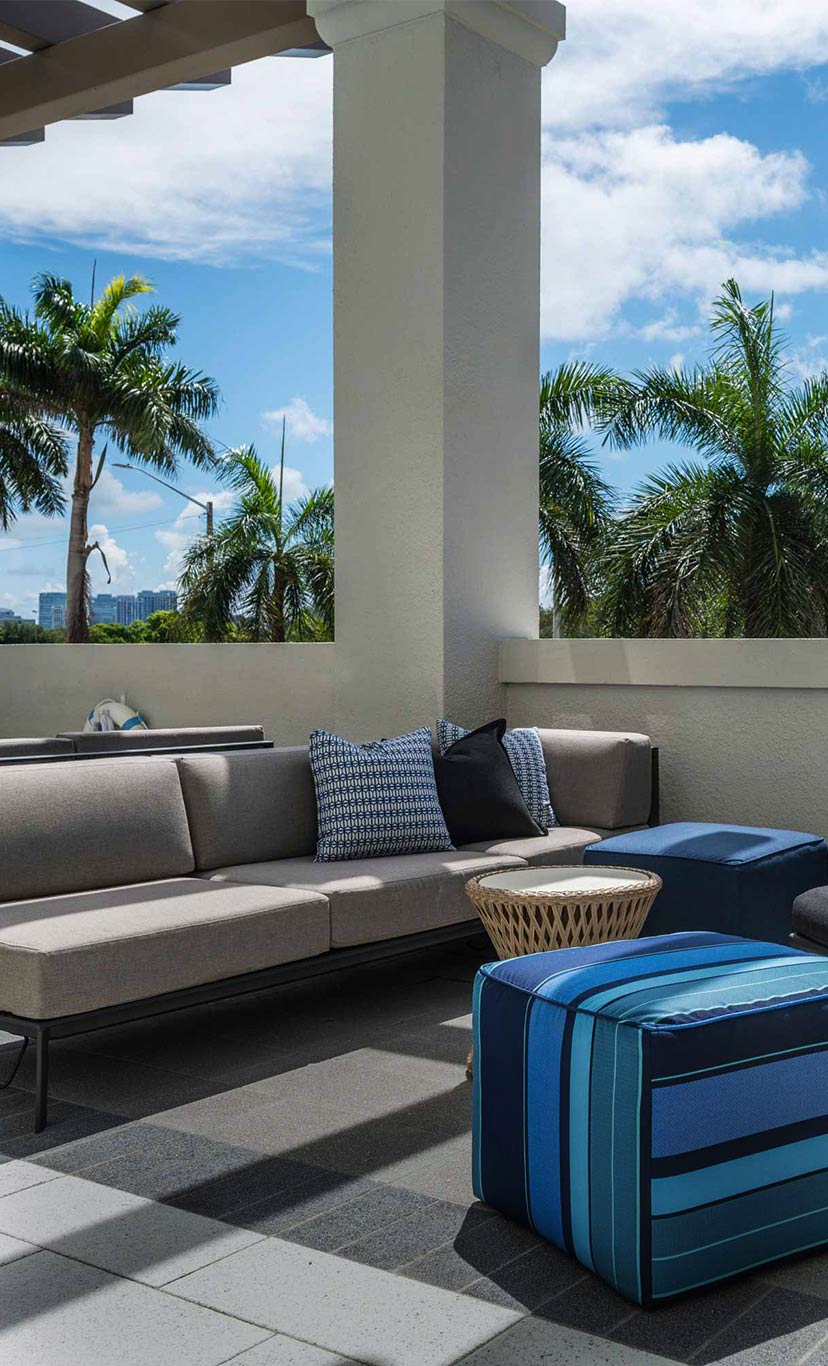 cabana seating with couches and small tables, awnings and curtains