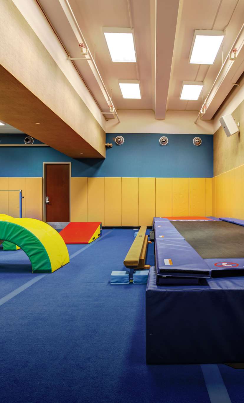A brightly colored kids tumbling studio with trampoline