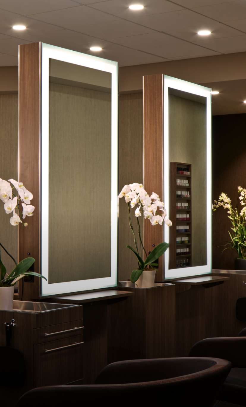 Vanity mirrors and chairs in a salon area