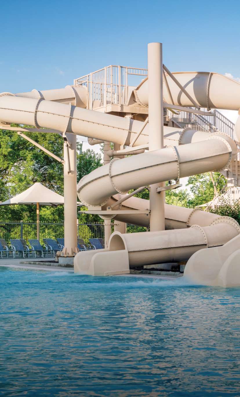 2 waterslides that empty into an outdoor pool