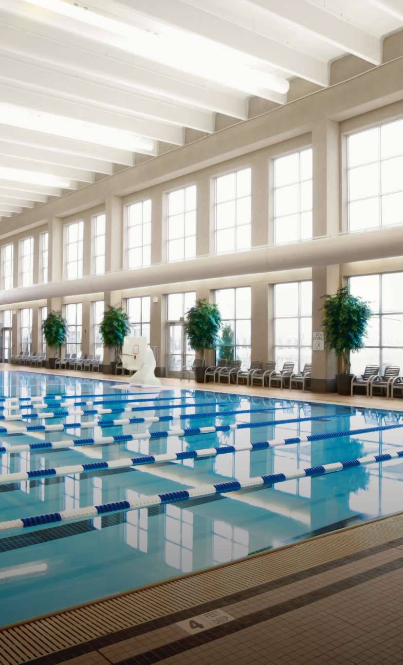 a multi lane lap pool with lane lines and zero depth entry in the background
