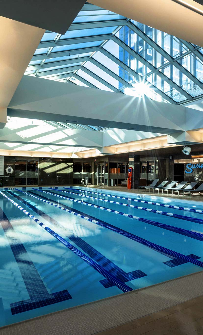 A view of an indoor 6 lane lap pool and deck