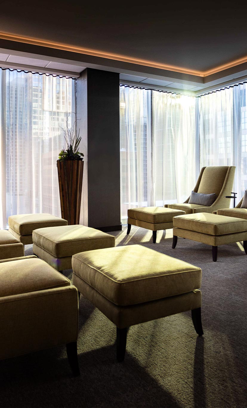 comfortable armchairs with ottomans in a spa relaxation area