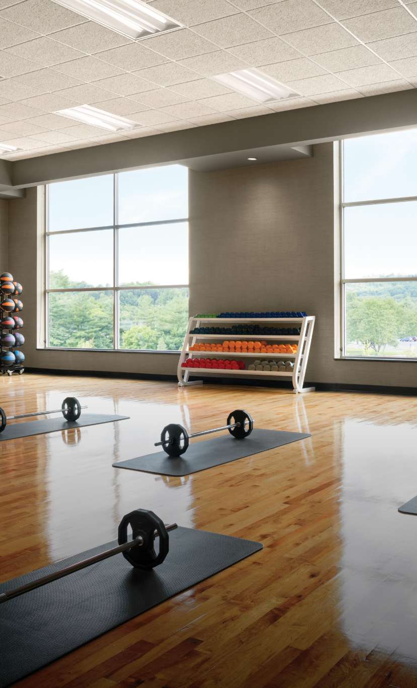 yoga mats and barbells in a bright studio workout space