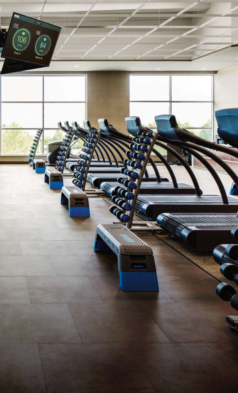 A group training workout area with treadmills and weights