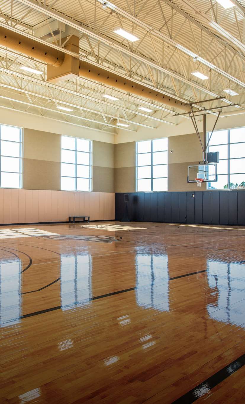 a brightly lit indoor basketball court