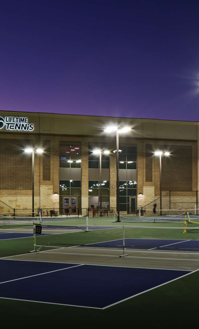 outdoor pickleball courts at a life time facility at dusk