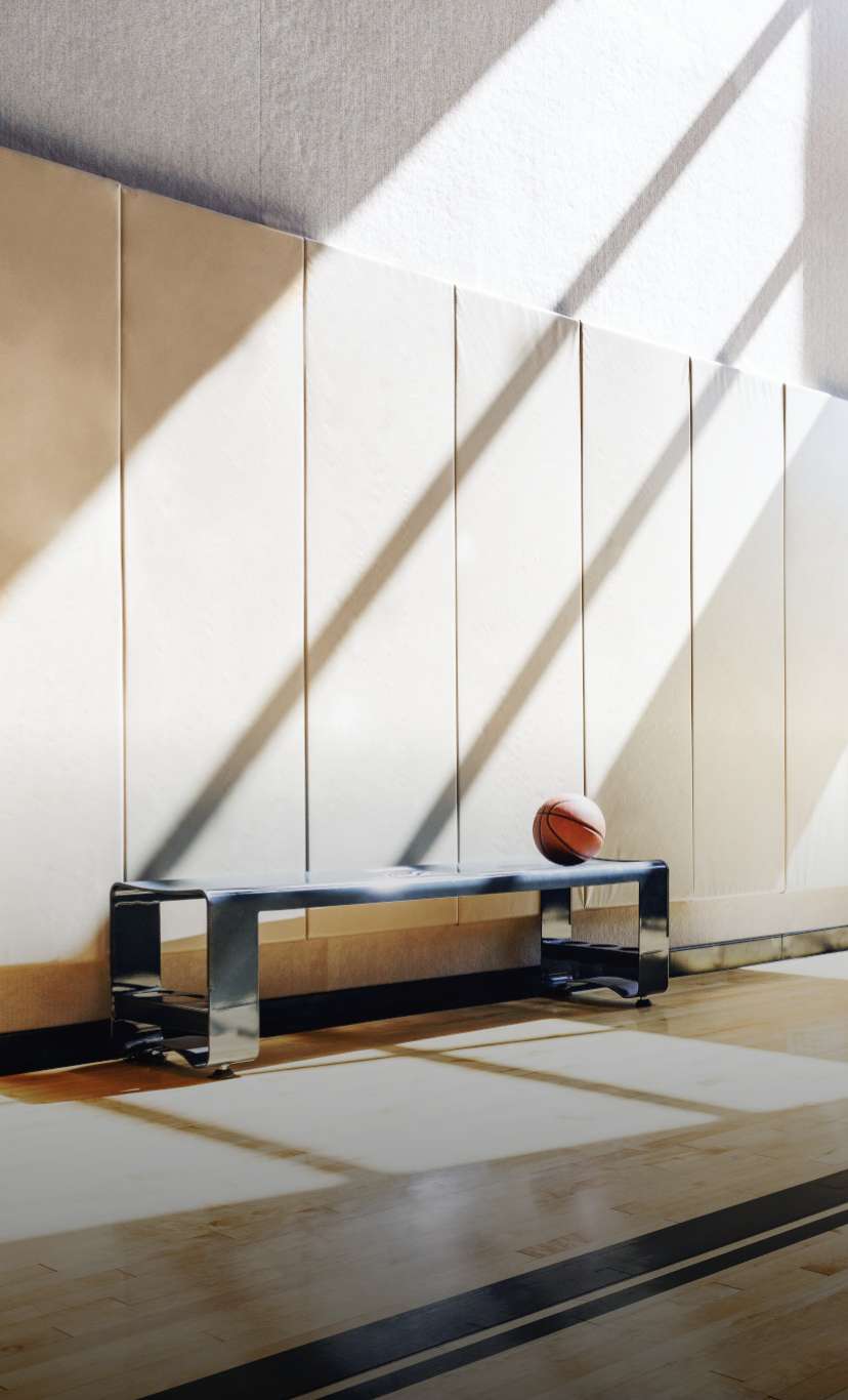 a basketball on a bench in a brightly lit gym