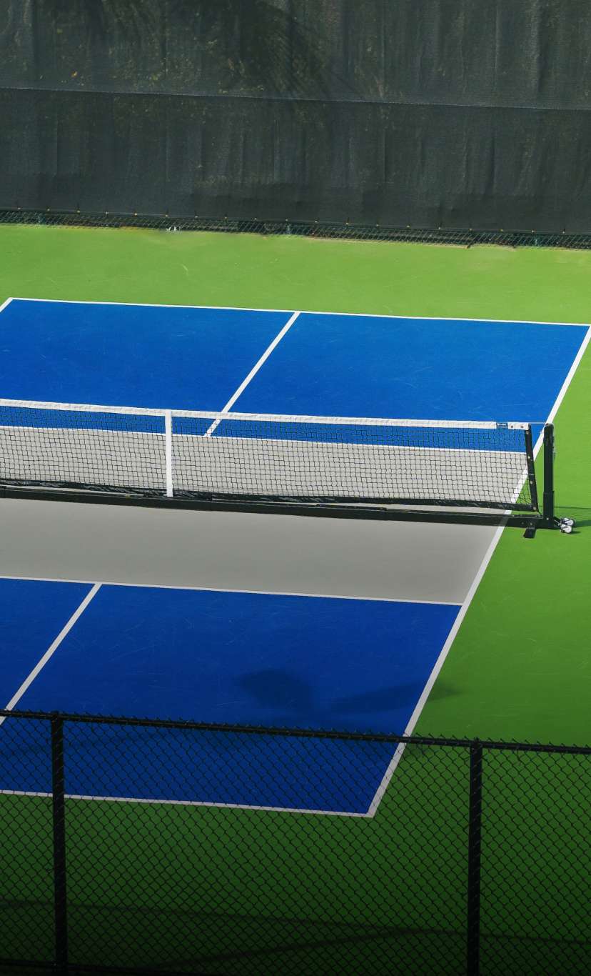 A blue and green indoor pickleball court
