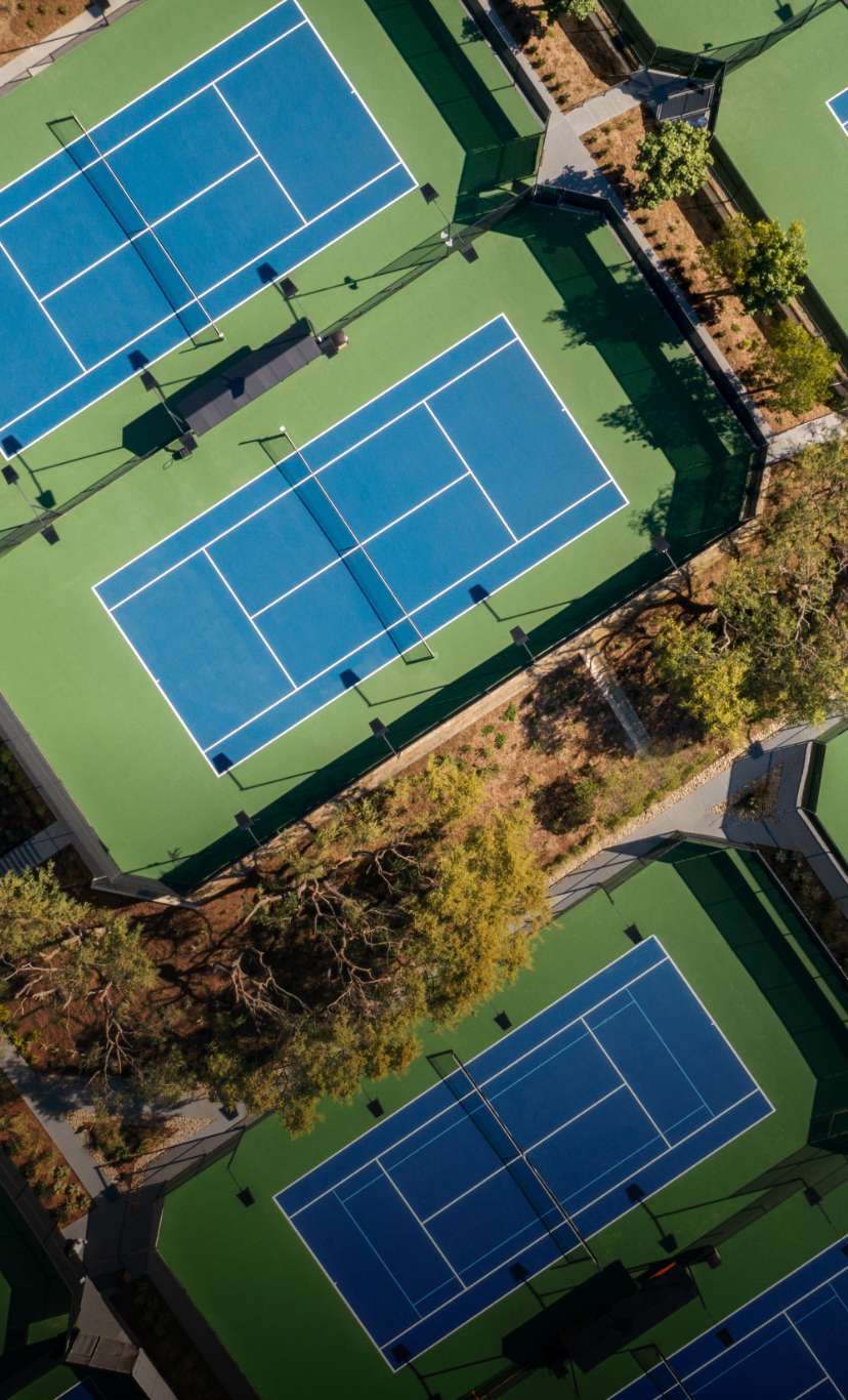An aerial view of 3 outdoor tennis courts