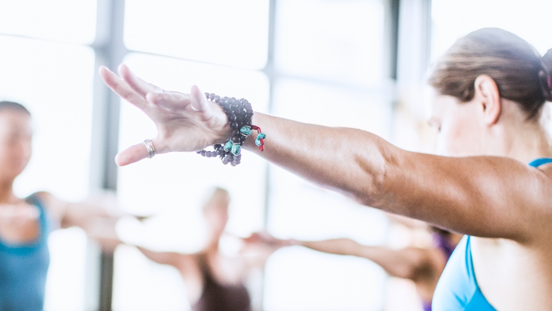 A woman practicing yoga in a group class
