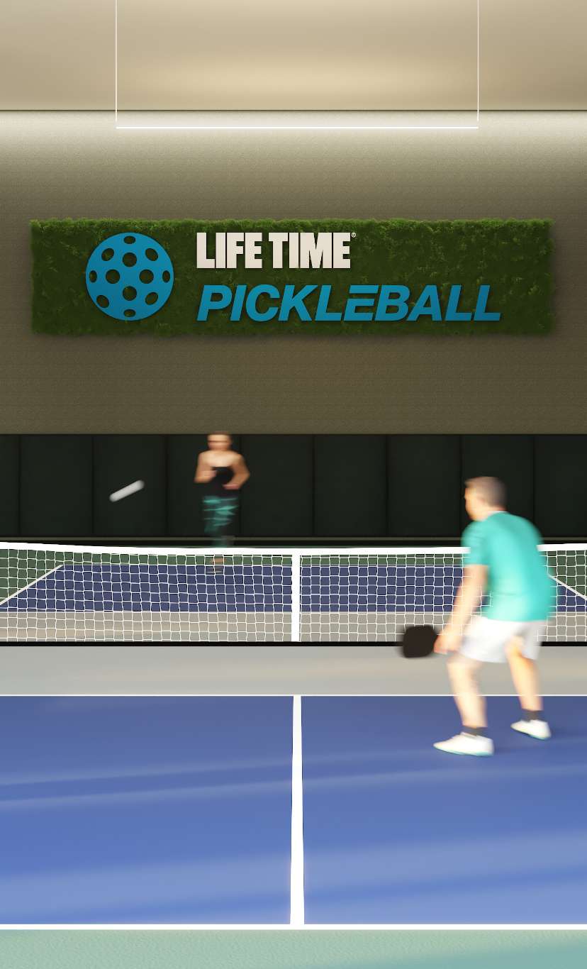 two people playing at in indoor pickleball court at Life Time