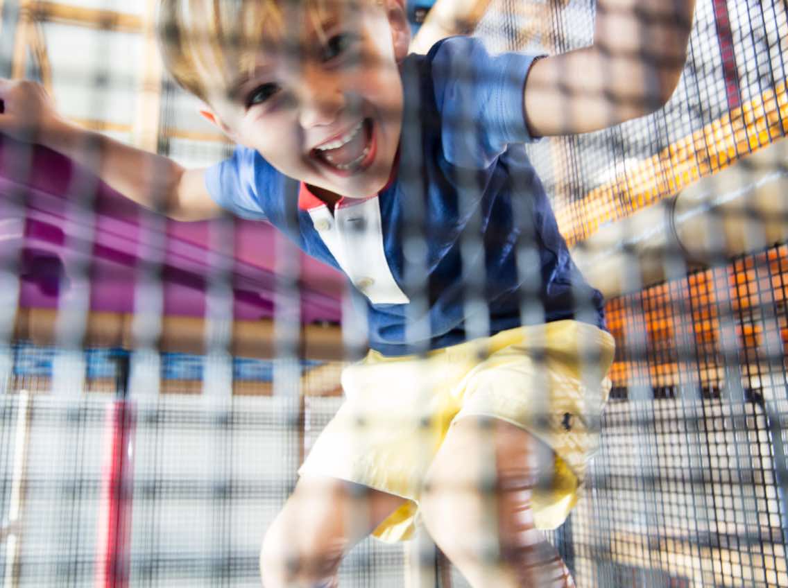 Male child playing on an indoor playground at Life Time