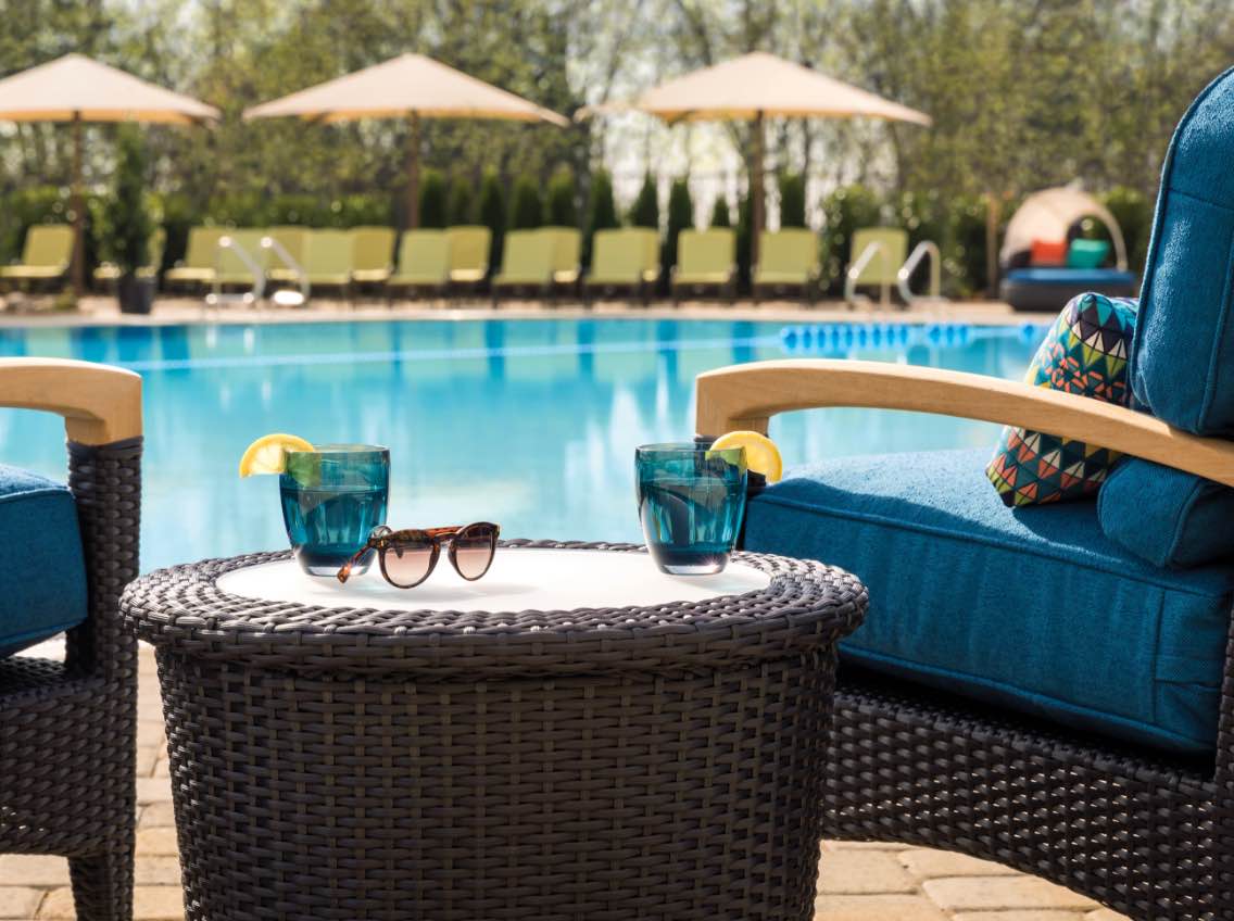 Image of lounge chairs next to a pool.