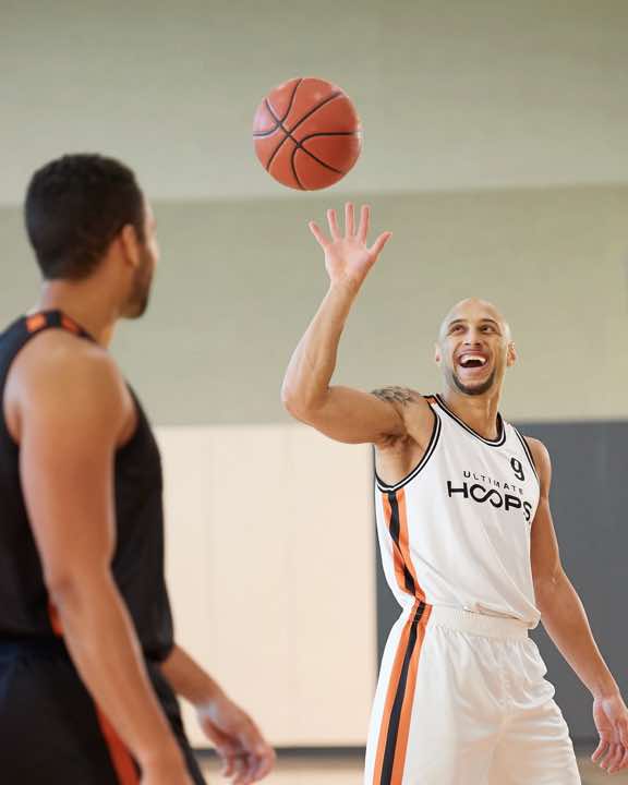 Two men playing basketball.  