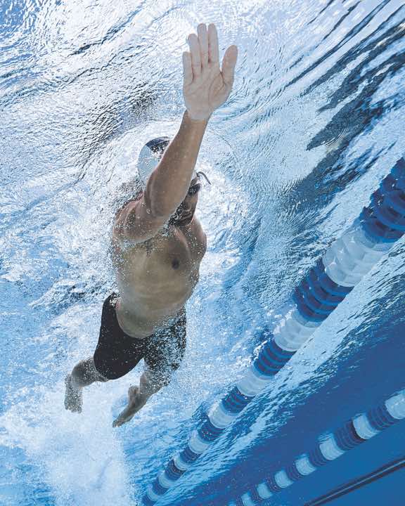 a man swiming inside a life time lap pool