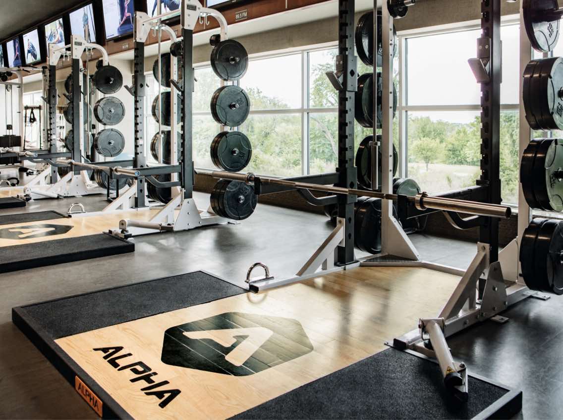 Alpha training area at Life Time with Olympic-style weight-training equipment