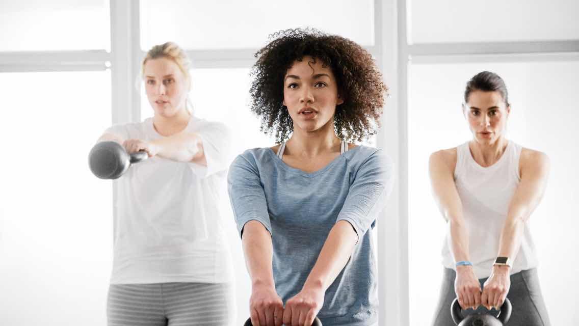 Three women taking a small group training class at Life Time.