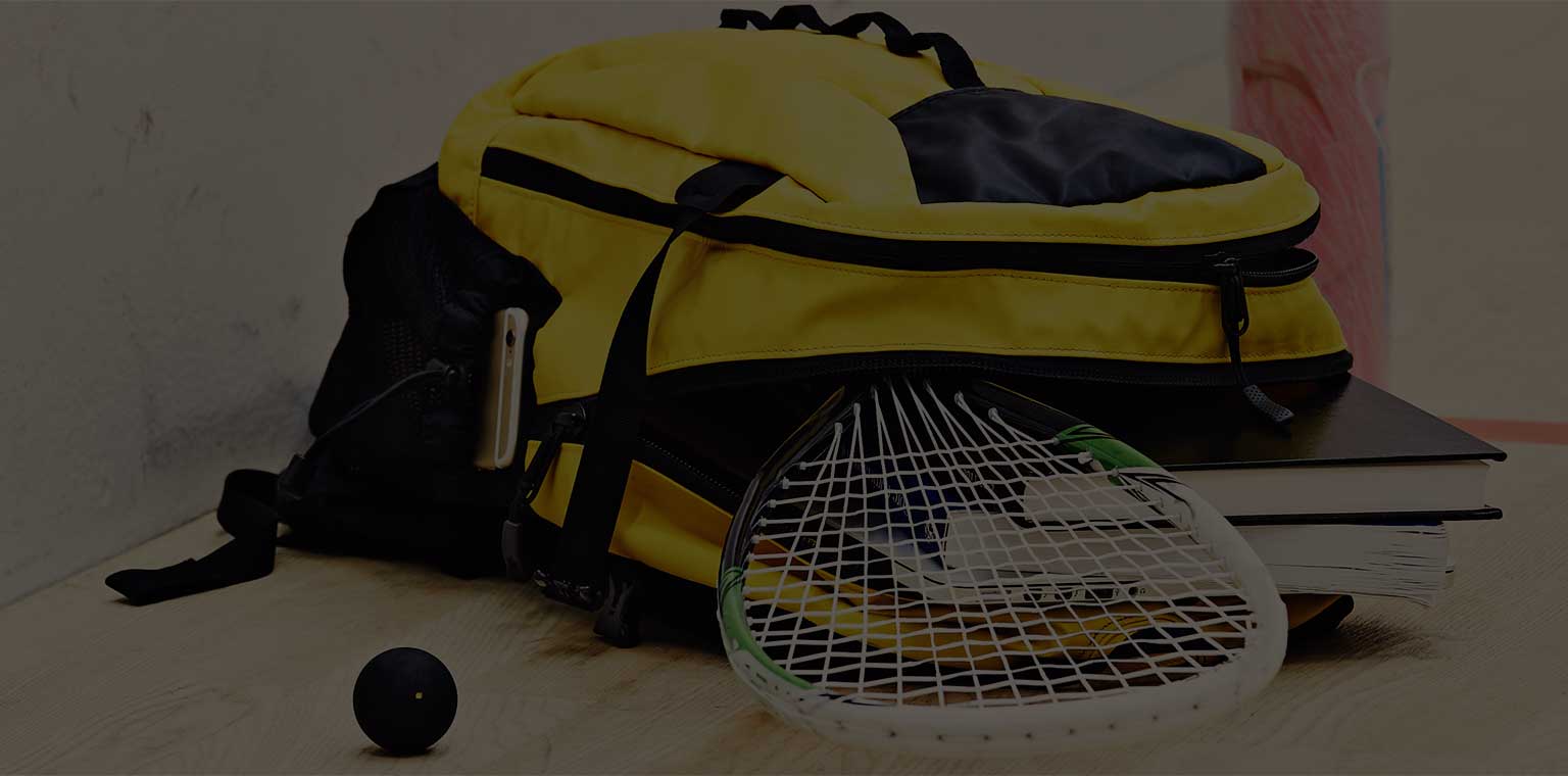 A child's backpack overflowing with books and squash gear.