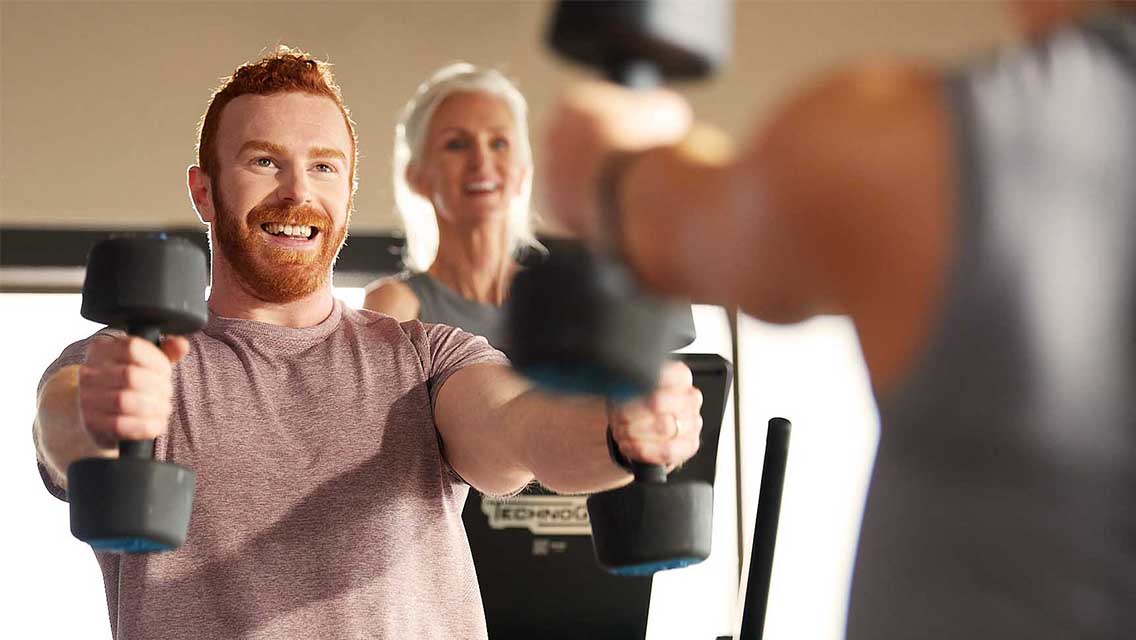 a man leading stretches to a group.