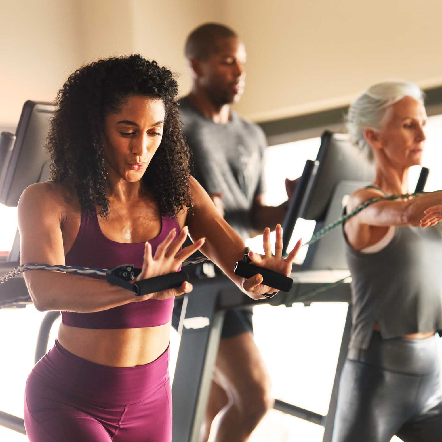group of people using resistance bands in a workout