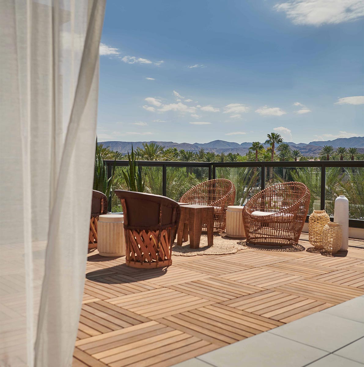 a luxury outdoor patio on a sunny day, with wicker furniture