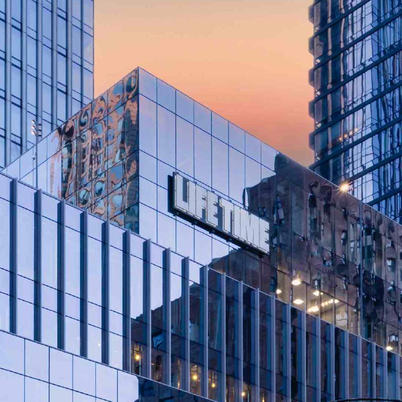Glass sky scrappers in downtown Chicago and the exterior of Life Time River North at One Chicago